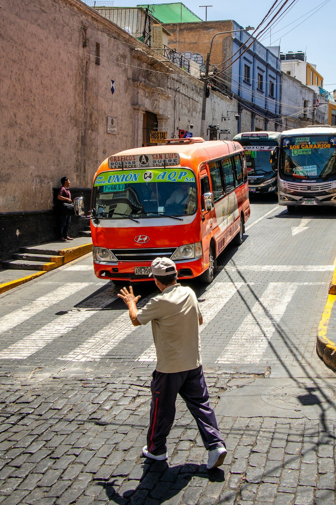 Public bus and pedestrians on a busy Latin American city street