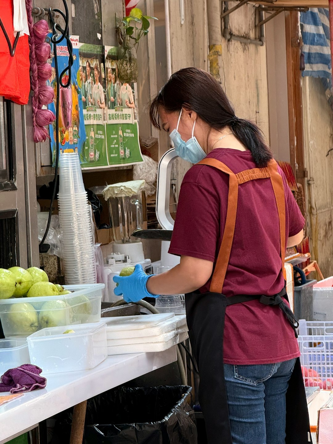 Vendor preparing fresh fruit at a street stall